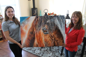 Photo by Wendy Gabrek Bravo Prospero's Encore – Marilyn Lee Jenkins (right) and Jessica Fobert of Orangeville, holding ‘Prospero's Encore'. The 25” x 36” original acrylic on canvas painting is up for raffle. Proceeds from the fundraiser will benefit the ongoing education of Ms Fobert, and her pursuit to elevate horsemanship to include an honest way to care for horses, with consideration for their feelings at the centre of her approach. The draw takes place on June 30th.