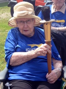 Norma Wallace holding the torch