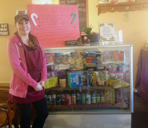 Photos by Michelle Janzen Tracy of Main Street Café standing beside the cooler that customers have filled.
