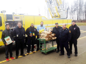 The Shelburne firefighters pictured with John owner of No Frills collecting toys and non perishable food items.